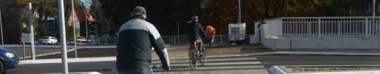 Kein Radweg, nirgends. Soweit es überhaupt Wege für sie gibt, sind Radler am Kreisel Ochsenzoll auf Zebrastreifen angewiesen. In Nord-Süd-Richtung ist eine Querung für sie nur mit minutenlangen Umwegen möglich (Foto: Infoarchiv) Radfahrer auf dem Zebrastreifen am Kreisel.